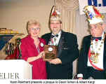 Karin Reinhard presents a plaque to David Simon and Albert Kergl (G.K.G. Narrhalla 58)