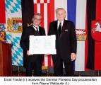 Ernst Friedel (r.) receives the German Pioneers Day proclamation from Wayne Wettlaufer (l.)