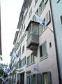 Medieval balcony on the river with flags of Zri