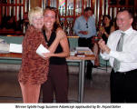 Winner Sybille hugs Susanne Adamczyk applauded by Dr. Arpad Slter