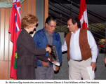 Dr. Marlene Epp hands the award to Lehmann Gibson & Paul Williams of the First Nations