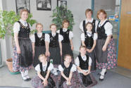 Lorie (l.) with children wearing Danube Swabian costumes