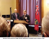 German Consul General Holger Raasch addresses a crowded room in Queen's Park