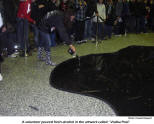 A volunteer poures fresh alcohol into the artwork called "Vodka Pool"  [photo: Claudia Raupach]