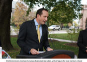 Erik Bremermann, German Canadian Business Association, with cheques for local German schools